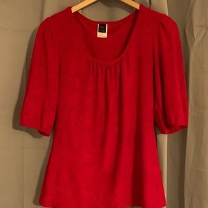 Vibrant red half sleeved dress top with stitched pattern for texture.